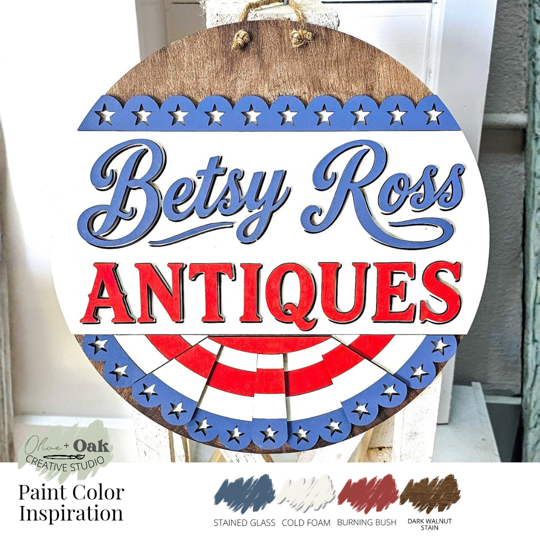 Wooden sign with 'Betsy Ross Antiques' text and patriotic design, featuring paint color inspiration at the bottom.