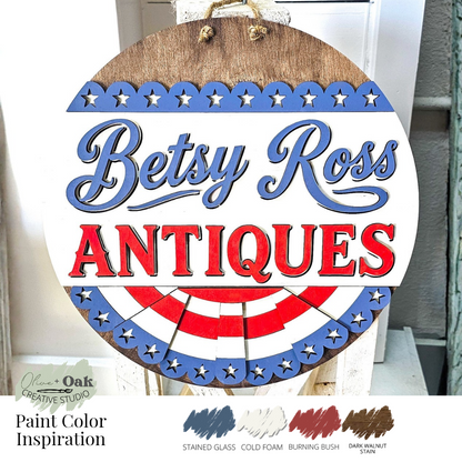 Wooden sign with 'Betsy Ross Antiques' text and patriotic design, featuring paint color inspiration at the bottom.